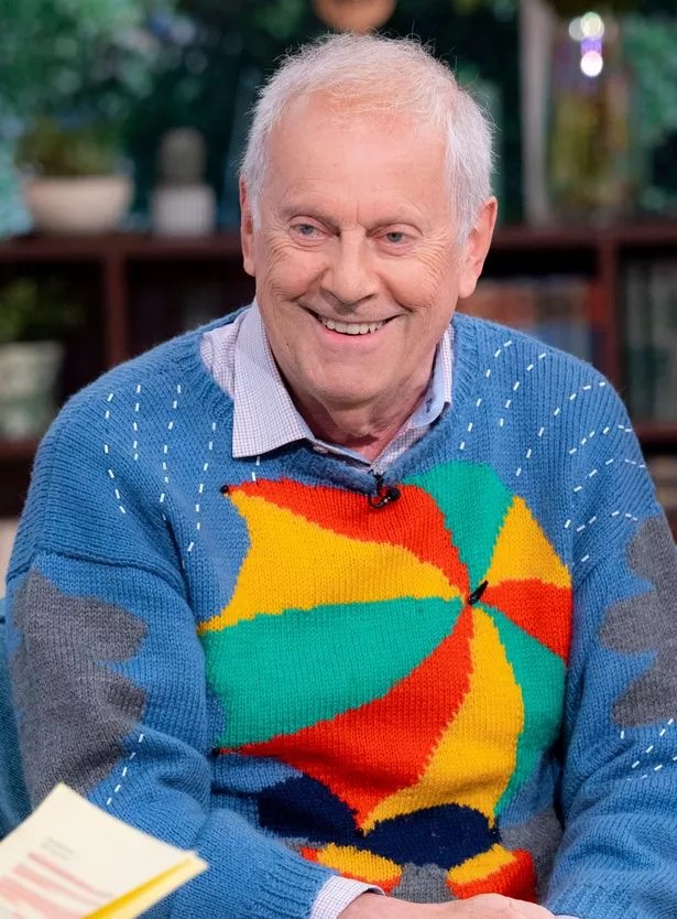 Giles Brandreth in a colourful sweater